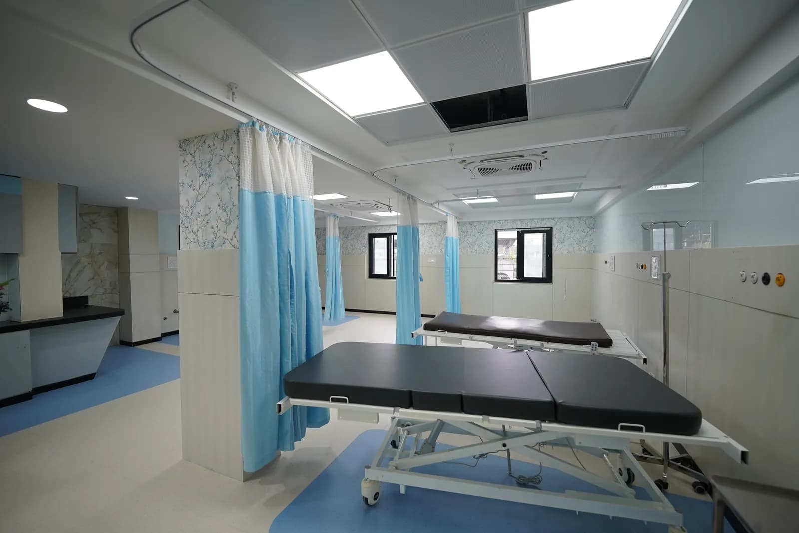 Patient care area with beds and curtains